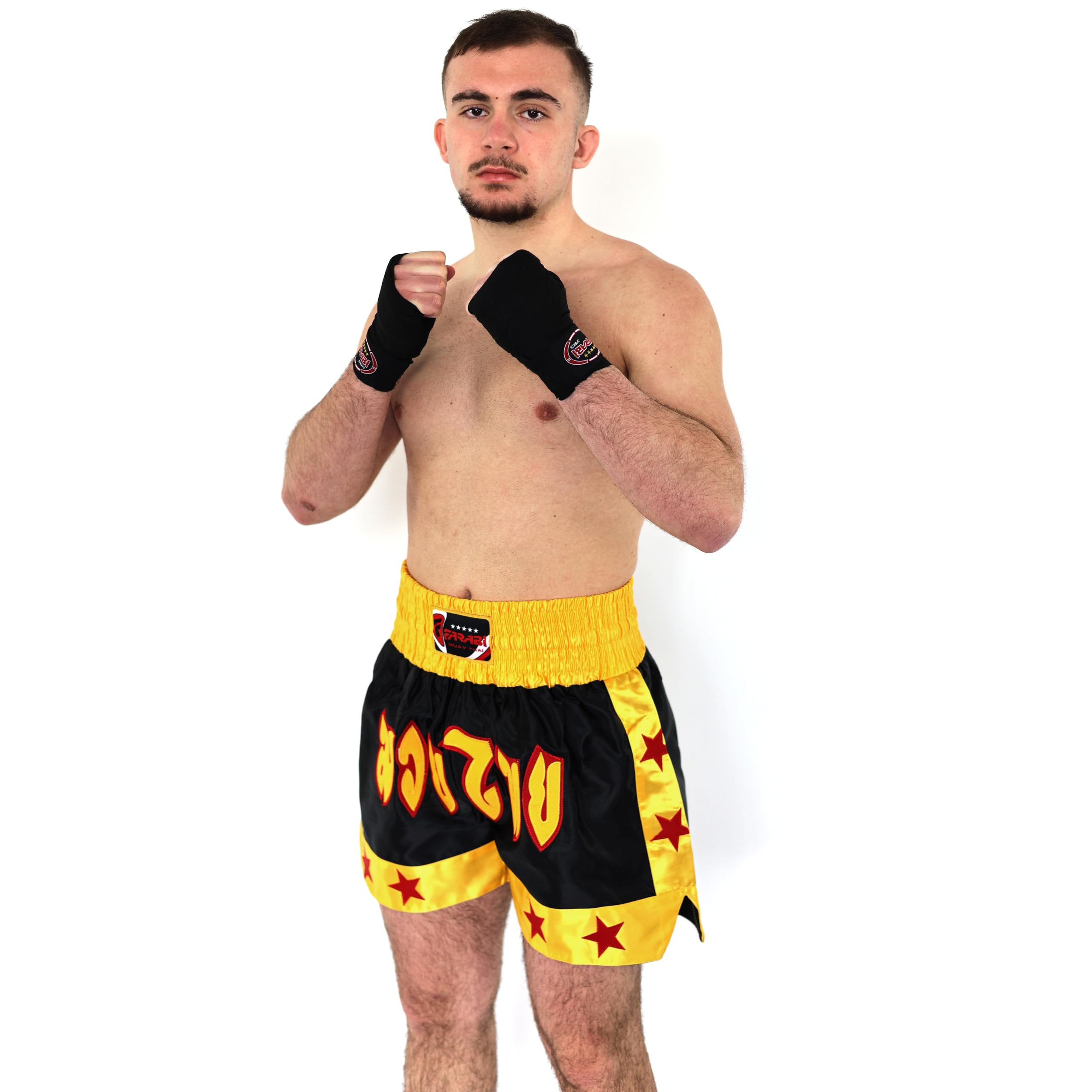 Farabi Sports Muay Thai fighter wearing black and yellow shorts with fiery lettering, showcasing readiness for combat.