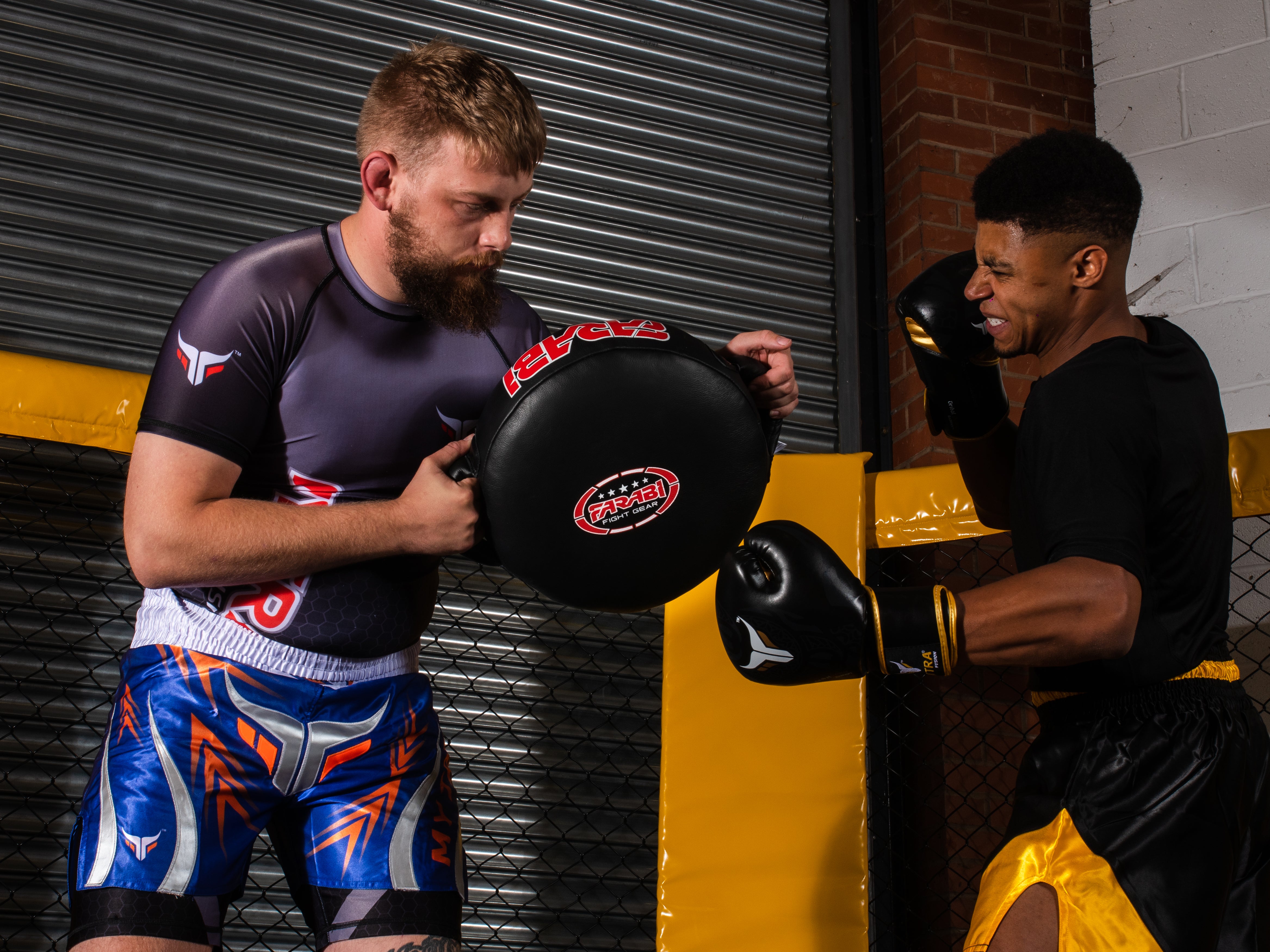 Farabi Sports boxing training session featuring a fighter practicing punches with focus mitts.